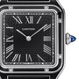 Close-up of a Cartier Pasha de Cartier wristwatch featuring a black square dial, silver Roman numerals, geometric accents, and a blue cabochon crown. The watch hands are set at 10:10.