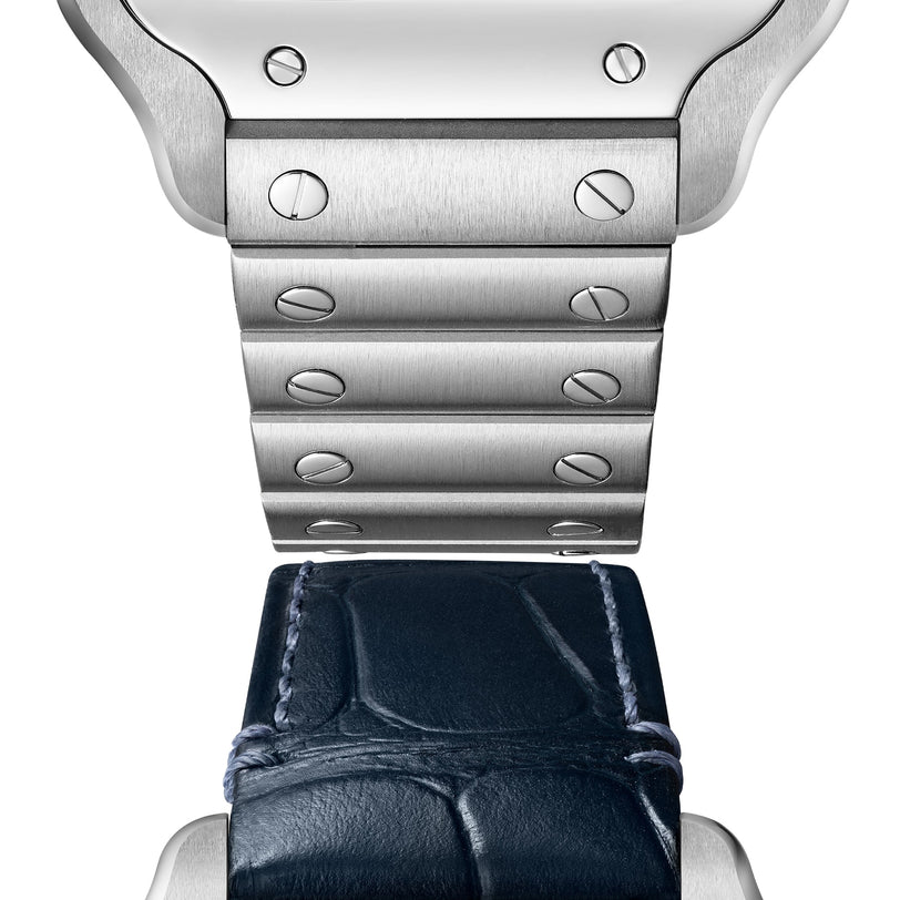 Close-up of the Cartier Santos de Cartier watch showcases the transition from a brushed metal bracelet with screws to a dark blue leather strap, both complemented by its signature square steel case.
