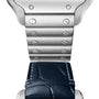 Close-up of the Cartier Santos de Cartier watch showcases the transition from a brushed metal bracelet with screws to a dark blue leather strap, both complemented by its signature square steel case.