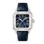 The Santos de Cartier by Cartier features a square silver case, blue dial with Roman numerals, date window at 3 o’clock, mechanical movement, and black leather strap—reflecting the brand’s historic connection to early aviation.
