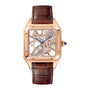 The Cartier Santos-Dumont Skeleton with Micro-Rotor features a square rose gold case, brown leather strap, and blue hands, displayed on a white background.