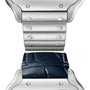 Close-up of the Santos de Cartier by Cartier, showing a silver case with both metal bracelet and black leather strap attached, highlighting its refined aviation-inspired design.