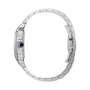 Profile view of the Santos de Cartier by Cartier, a silver metal aviation watch with a blue crown and linked bracelet band, showcasing its slim case and refined mechanical movement.