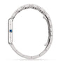 The Cartier Tank Must de Cartier is a silver wristwatch with a steel case, metal link band, blue crown, and quartz movement, shown from the side.