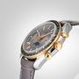 The OMEGA Speedmaster Moonphase is a luxury wristwatch with a grey leather strap, silver dial featuring multiple subdials and a Moonphase display, and distinguished by its 18K yellow gold bezel and pushers.