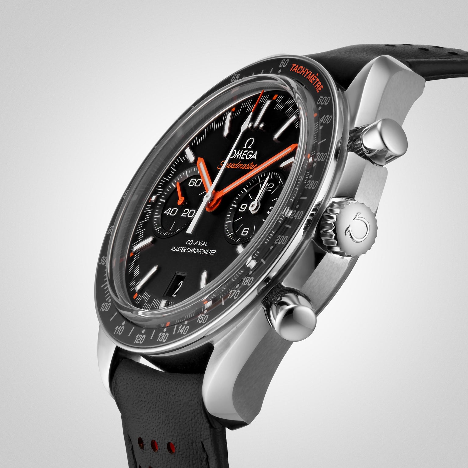 Close-up of the OMEGA Speedmaster Racing, a black wristwatch with chronograph display, silver case, black leather strap, and red accents on the hands and tachymeter scale, powered by the precise 9900 calibre movement.