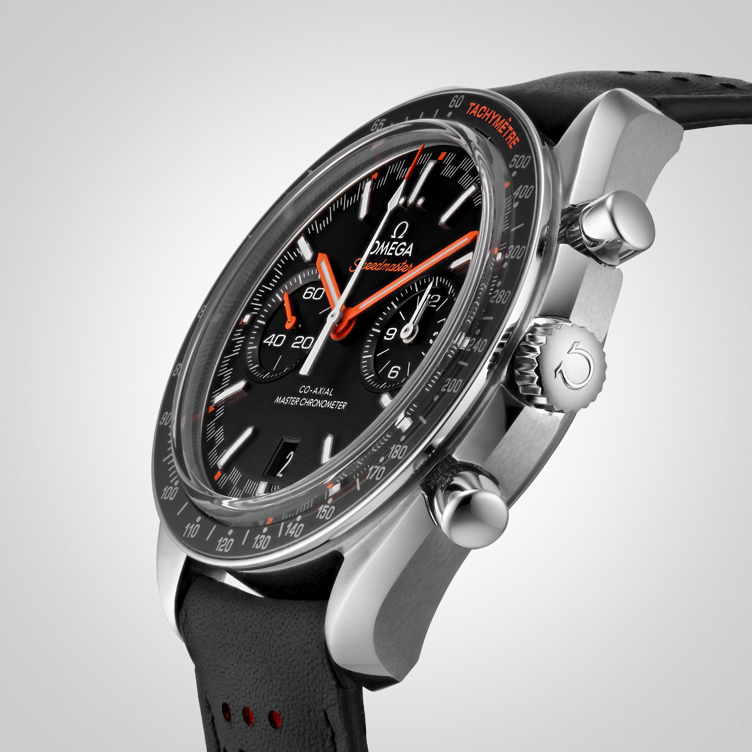 Close-up of the OMEGA Speedmaster Racing, a black wristwatch with chronograph display, silver case, black leather strap, and red accents on the hands and tachymeter scale, powered by the precise 9900 calibre movement.