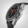 Close-up of the OMEGA Speedmaster Racing, a black wristwatch with chronograph display, silver case, black leather strap, and red accents on the hands and tachymeter scale, powered by the precise 9900 calibre movement.