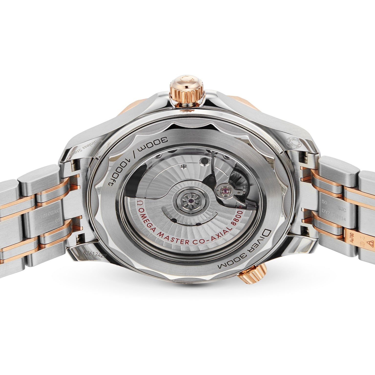 Close-up of the back of an OMEGA Seamaster Diver 300M, highlighting its transparent case with visible movement, engraved details on the metal, and a strap combining silver and rose gold tones.