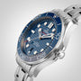 The OMEGA Seamaster Diver 300M features a stainless steel case, blue ceramic bezel, wave-patterned blue dial with luminous markers, and a metal bracelet, powered by the Master Chronometer Calibre 8800, shown on a plain background.