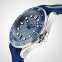A close-up of the OMEGA Seamaster Diver 300M, featuring a wavy blue dial, luminous hour markers, and a blue rubber strap.