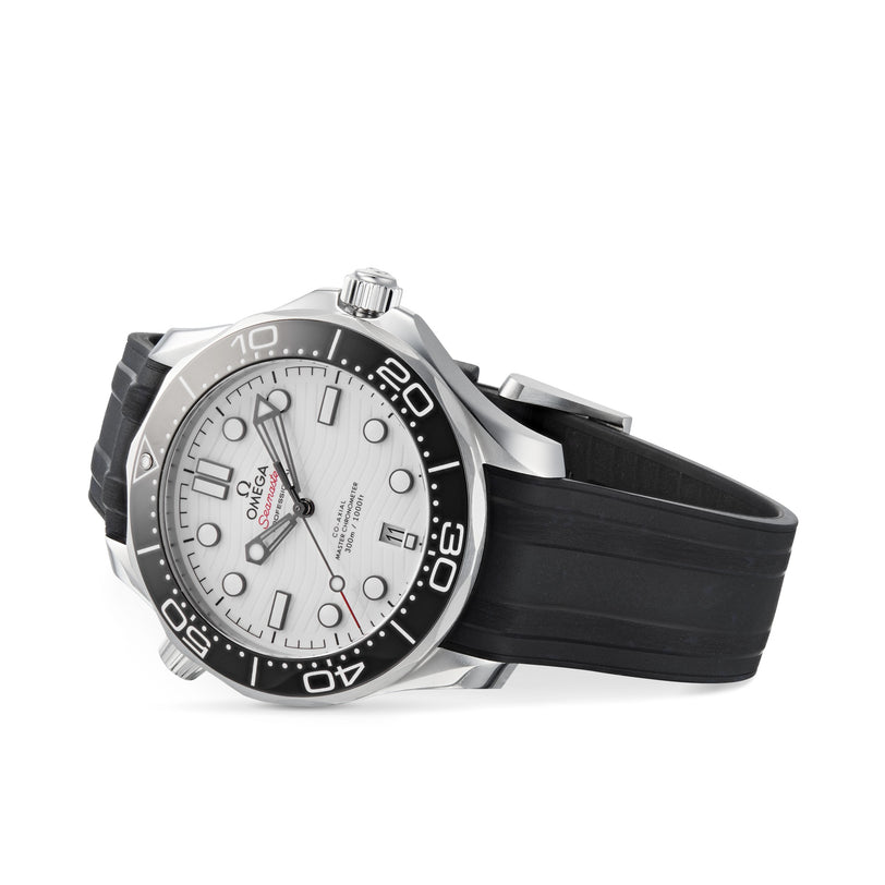 An OMEGA Seamaster Diver 300M wristwatch is shown angled on a white background, featuring a silver case, black ceramic bezel, white dial, and black rubber strap. It is powered by the precise OMEGA Calibre 8800 movement.