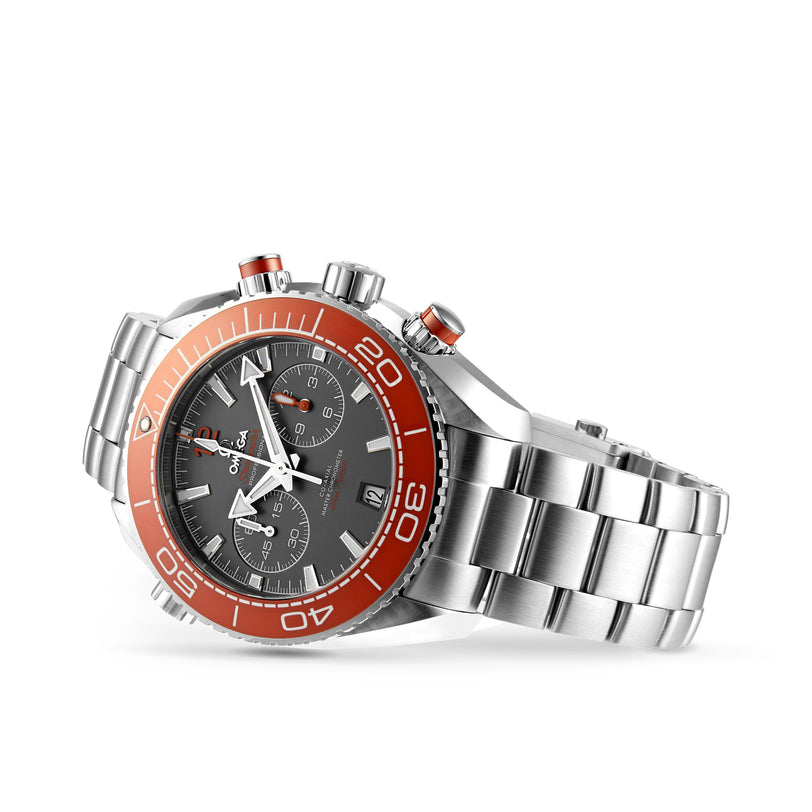 The OMEGA Seamaster Planet Ocean 600M features a stainless steel case, silver band, orange bezel, dark face with three subdials, date display, and advanced 9900 calibre movement inspired by Seamaster heritage.