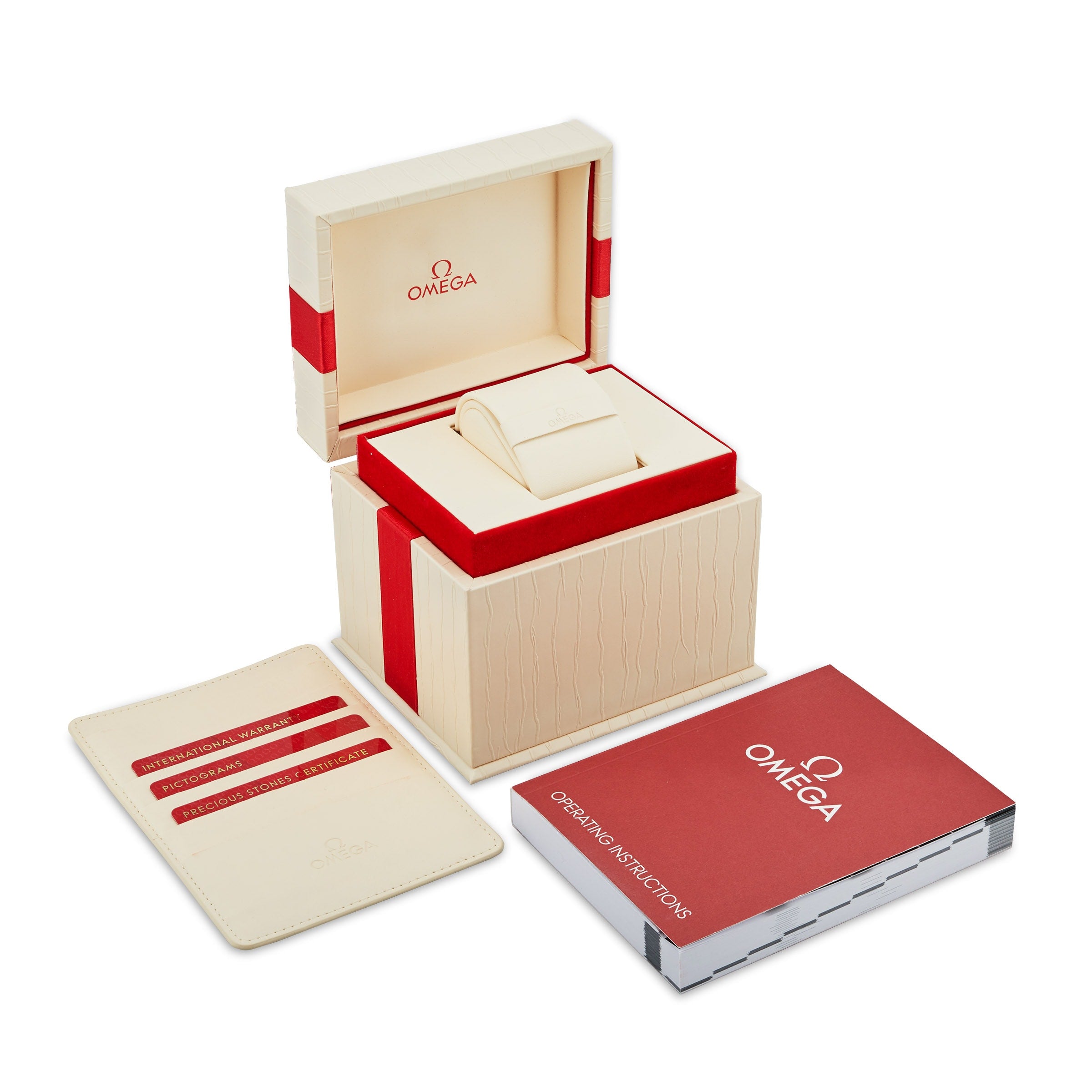 An open beige OMEGA Constellation watch box with red accents reveals a cushion inside. Beside it are a certificate holder with cards and an Operating Instructions booklet—ideal for OMEGA Constellation enthusiasts.