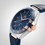 A close-up of the OMEGA Constellation watch with a blue dial, rose gold details, Roman numerals, a blue leather strap, and Master Chronometer 8900 calibre—showcasing OMEGA’s renowned Constellation craftsmanship.