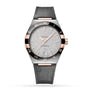 The OMEGA Constellation is a luxury wristwatch featuring a silver textured dial, rose gold accents, date at 6 o’clock, black bezel with Roman numerals, grey leather strap, and Master Chronometer-certified 8900 calibre movement.