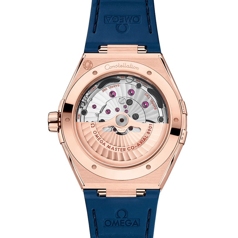 Back view of the OMEGA Constellation in Sedna™ gold, featuring a transparent case back, visible 8901 calibre Master Co-Axial movement with engraving, and a blue strap.