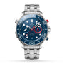 The OMEGA Seamaster Diver 300M Americas Cup Edition features a stainless steel case, blue dial with white markers, chronograph subdials, and a metal bracelet, displayed on a white background.
