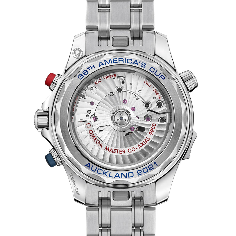 Close-up of the back of a silver OMEGA Seamaster Diver 300M Americas Cup Edition watch with a transparent case displaying the movement, inscribed with “36th America’s Cup Auckland 2021.”.