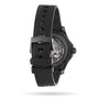 The OMEGA Seamaster Diver 300M Black Black Edition is seen from the back, highlighting its clasp, rubber strap, and partially visible mechanical movement through the caseback.