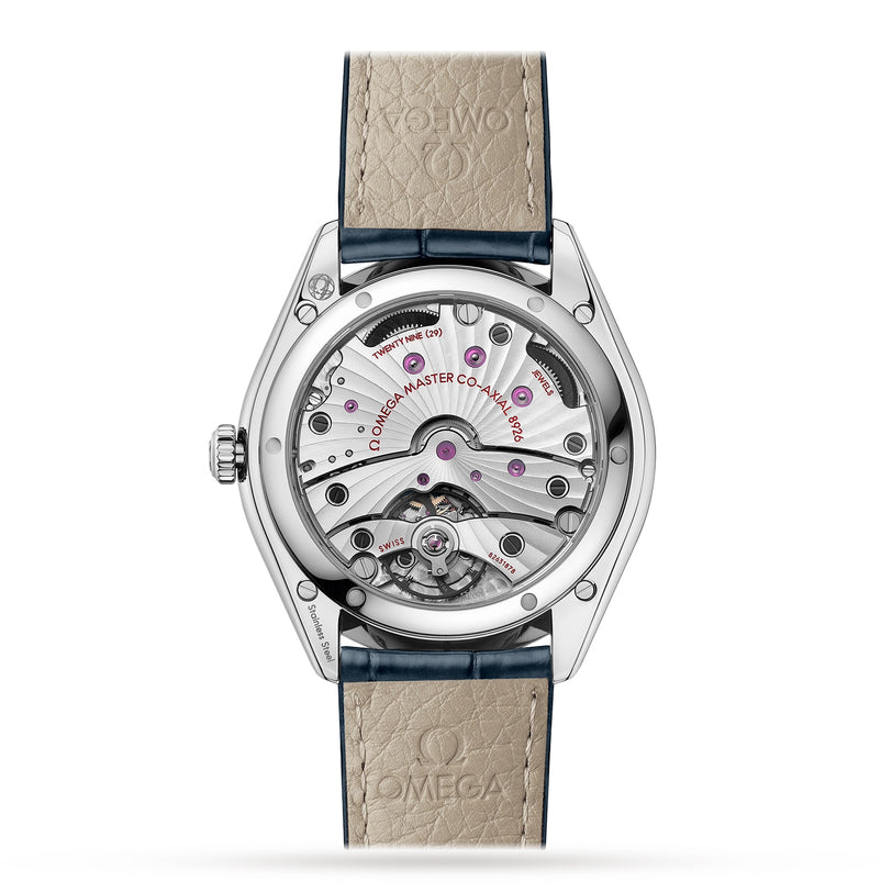 The back of the OMEGA De Ville Trésor showcases its exposed Master Chronometer movement through a transparent caseback, paired with a beige leather strap featuring the OMEGA logo.