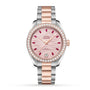 The OMEGA Seamaster Aqua Terra 150M ladies watch boasts a pink dial, diamond bezel, ruby hour markers, date at 6 o’clock, and a stainless steel and rose gold bracelet—crafted to OMEGA Master Chronometer standards.