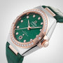 Close-up of the OMEGA Constellation featuring a green dial with diamond markers, an 18K Sedna™ gold bezel, and a matching green leather strap.