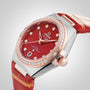 The OMEGA Constellation is a luxury watch with a red dial, diamond hour markers, rose gold bezel, and red leather strap, Master Chronometer certified for precision, displayed against a plain background.