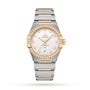 The OMEGA Constellation is a two-tone wristwatch with diamond-paved bezel, gold accents, a silver dial with gold hour markers, Master Chronometer Calibre 8800 movement, and a date window at 6 o’clock.