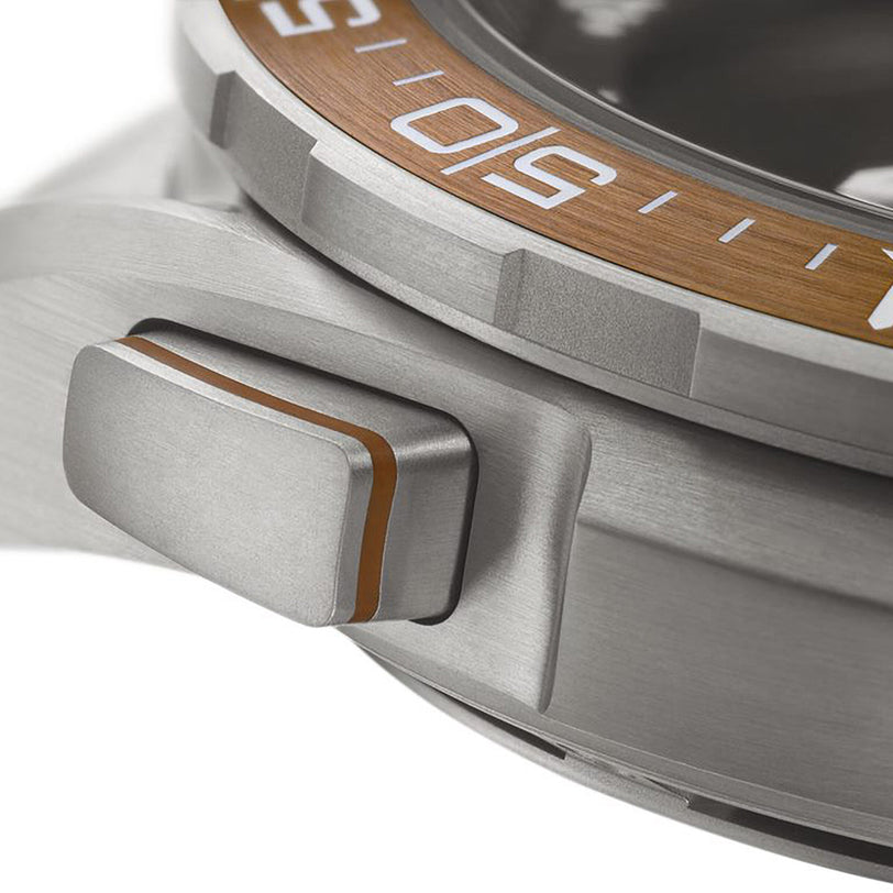 Close-up of the OMEGA Speedmaster X‑33 Marstimers silver titanium case, highlighting its crown with an orange accent stripe and a partial view of the bezel marked with 50.