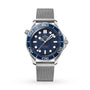 The OMEGA Seamaster Diver 300M James Bond 007 60th Anniversary watch features a blue bezel, wave-patterned blue dial with white hour markers, and mesh bracelet, powered by the Master Co-Axial 8806 movement, shown on a white background.