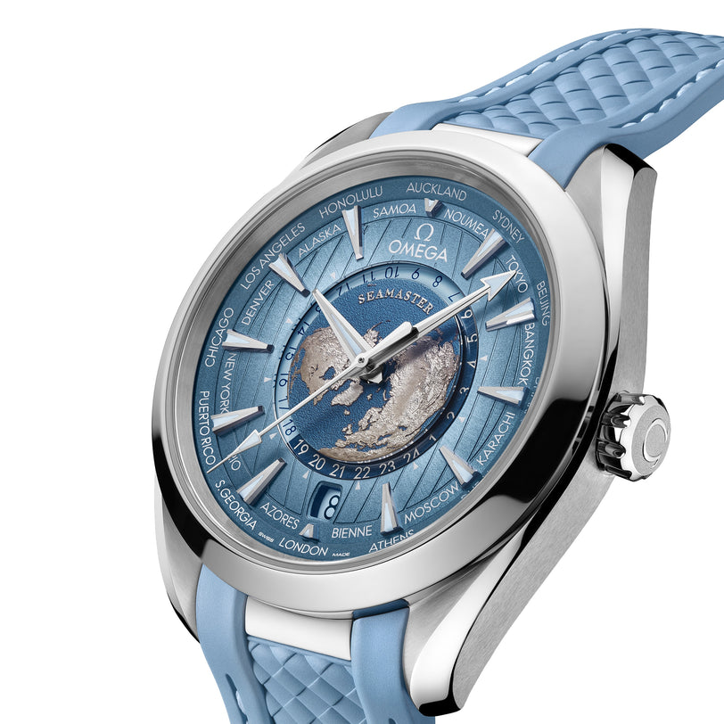 A close-up of an OMEGA Seamaster Aqua Terra 150M wristwatch featuring a stainless steel case, blue strap, world city names, textured blue dial, and central map design.