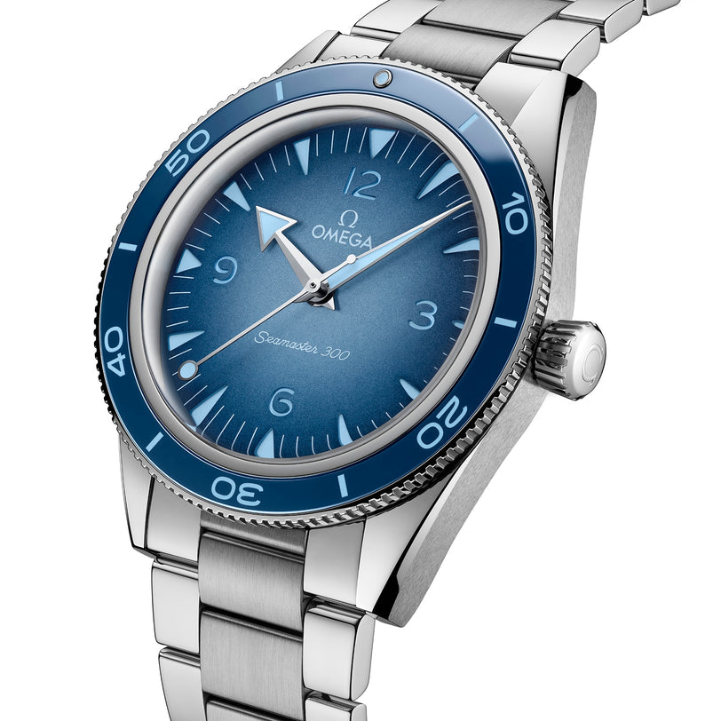 A close-up of the OMEGA Seamaster 300 Summer Blue, showcasing its blue dial and bezel, stainless steel bracelet, and Co-Axial Master Chronometer calibre 8912.