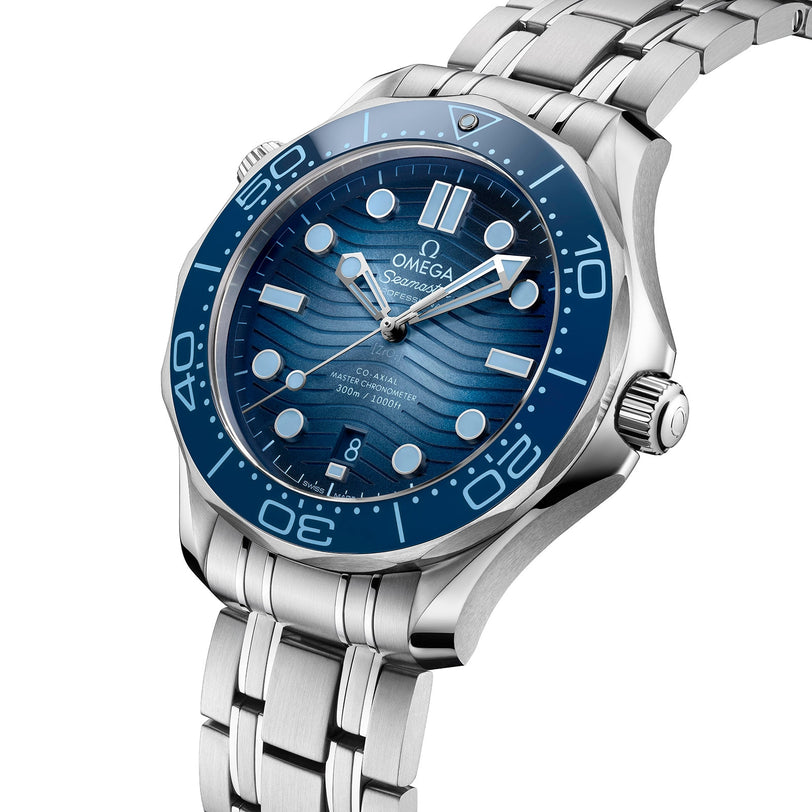Close-up of the OMEGA Seamaster Diver 300M Summer Blue, featuring a wave-patterned blue dial, silver hour markers, and stainless steel bracelet—crafted to Master Chronometer standards.
