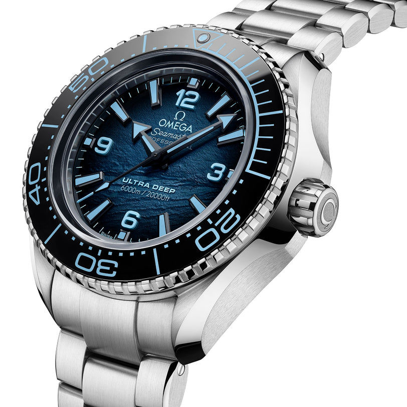 A close-up of the OMEGA Seamaster Planet Ocean 6000M wristwatch with a blue textured dial, silver hour markers, and a sturdy O-MEGASTEEL bracelet—an outstanding addition to professional saturation divers’ timepieces.