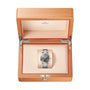 An OMEGA Seamaster Aqua Terra 150M stainless steel wristwatch with a dark dial, certified as a Master Chronometer, displayed in an open light wood Omega presentation box.