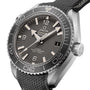 A close-up of the OMEGA Seamaster Planet Ocean 600M dive watch with a gray dial, bold white hour markers, and a textured black strap emphasizes its Co-Axial Master Chronometer precision.