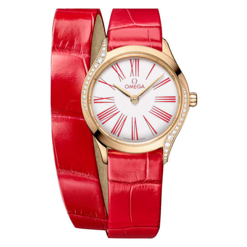 The OMEGA De Ville Mini Trésor features a red leather double wrap strap, 18K Moonshine™ Gold case, white dial with red Roman numerals, and diamond accents along the side of the case.