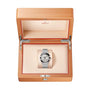 An OMEGA Constellation wristwatch with a meteorite dial is displayed inside an open wooden OMEGA box with a beige interior.