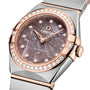 Close-up of the OMEGA Constellation wristwatch, showcasing a brown meteorite dial, diamond hour markers, and diamond-paved bezel in a blend of rose gold and stainless steel.