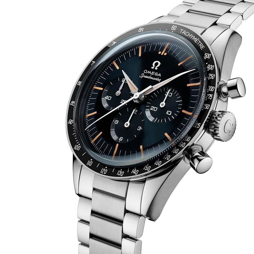 A close-up of an OMEGA Speedmaster First OMEGA in Space wristwatch featuring a black dial, three subdials, a tachymeter bezel, and a stainless steel bracelet.