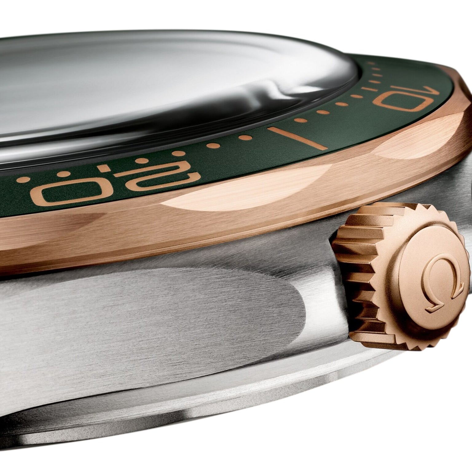 Close-up of the OMEGA Seamaster Diver 300M showcasing its green bezel with gold numbers, domed crystal, Omega-logo crown, and elegant 9K Bronze Gold accents.