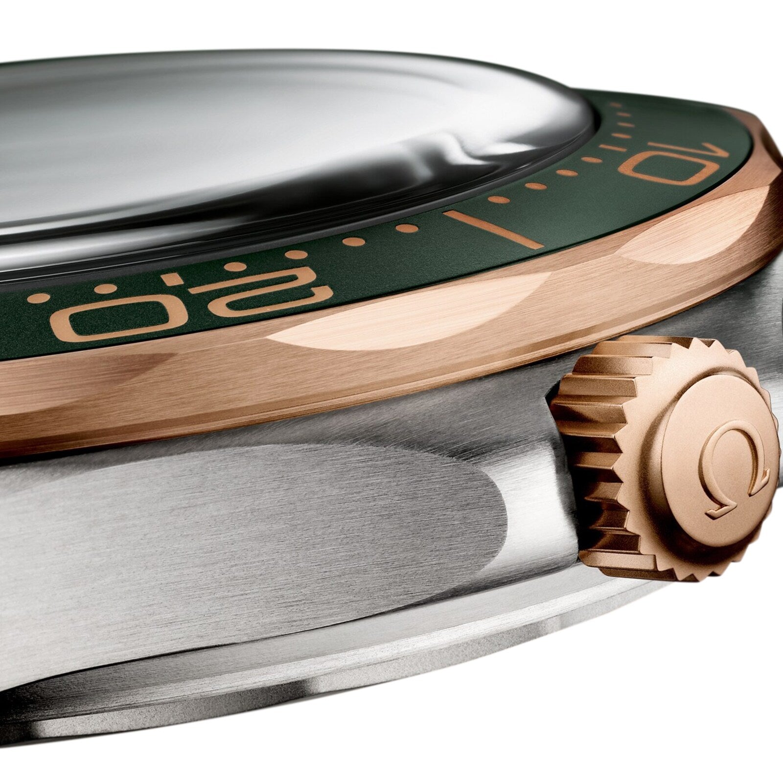 Close-up of the OMEGA Seamaster Diver 300M showcasing its green bezel with gold numbers, domed crystal, Omega-logo crown, and elegant 9K Bronze Gold accents.