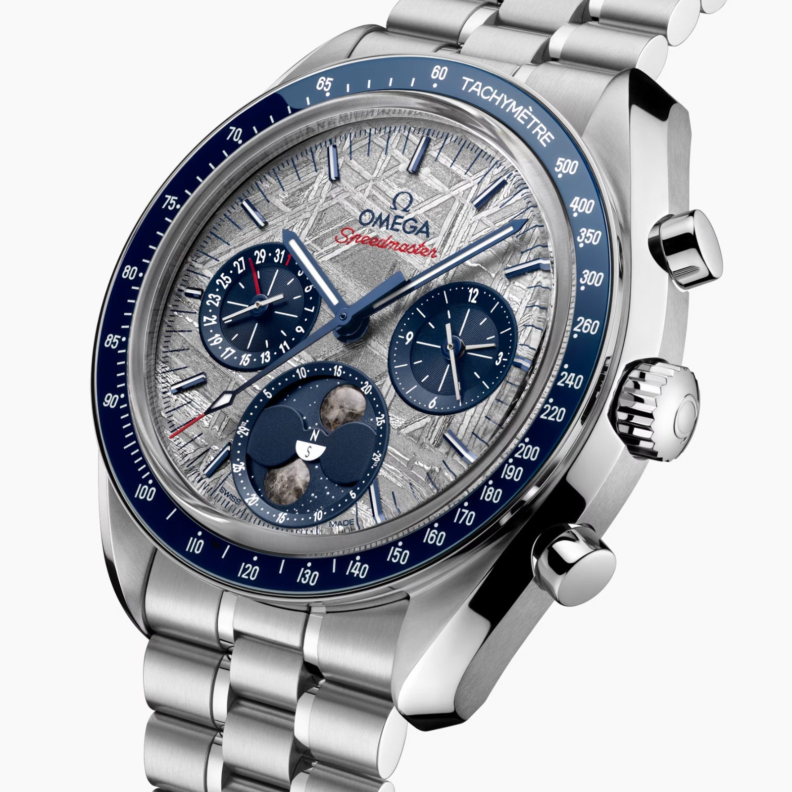A close-up of the OMEGA Speedmaster Moonphase Meteorite watch featuring a silver and blue face, multiple subdials, OMEGA Co-Axial Master Chronometer movement, and a stainless steel bracelet.