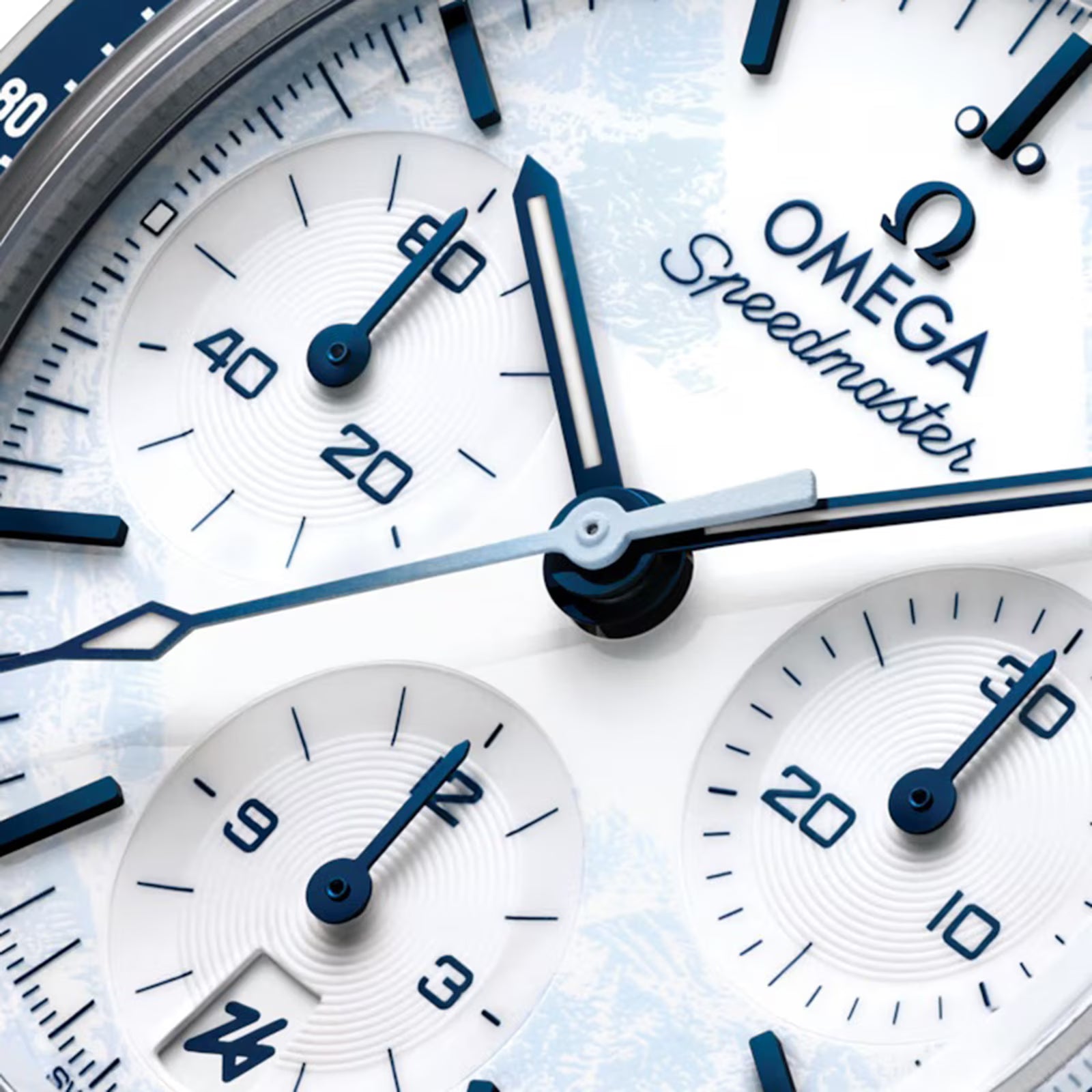 Close-up of an Omega Speedmaster watch face with blue and silver details.