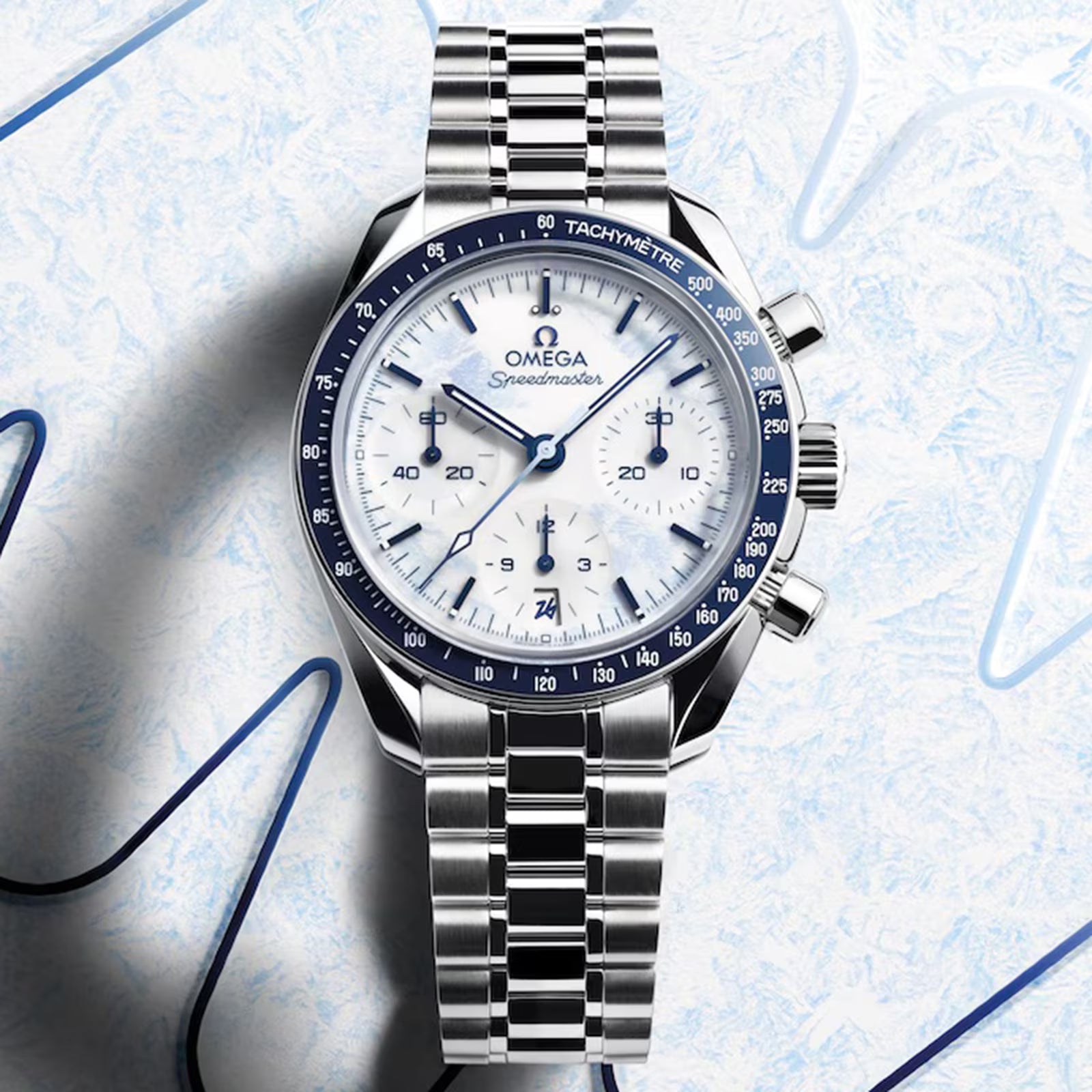 Silver Omega watch with a detailed face on a light blue textured background