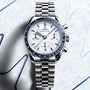 Silver Omega watch with a detailed face on a light blue textured background