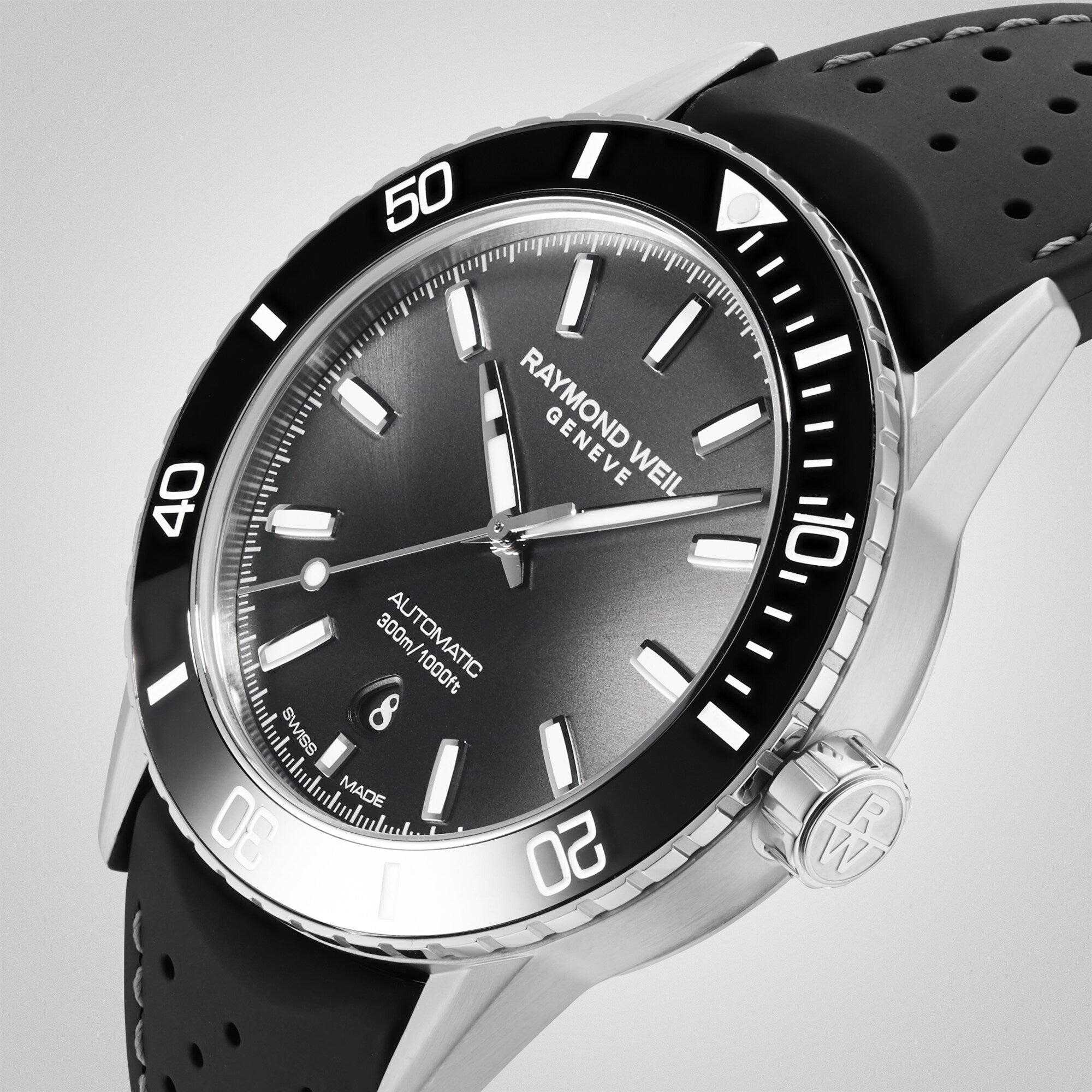 The Raymond Weil Freelancer Diver Black Dial watch features a sleek black dial, black bezel, perforated strap, and date display at 6 o’clock—a refined choice for those seeking affordable luxury.