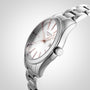 A Longines Conquest Classic wristwatch featuring a stainless steel case, metal band, white dial, and rose gold markers and hands, shown from an angled side view.