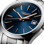 Close-up of a Longines Conquest Classic wristwatch featuring a blue dial, gold hour markers and hands, date display at 3 o’clock, stainless steel case, and silver metal bracelet.